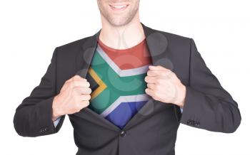 Businessman opening suit to reveal shirt with flag, South Africa