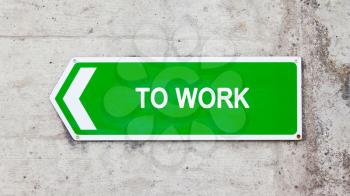 Green sign on a concrete wall - To work