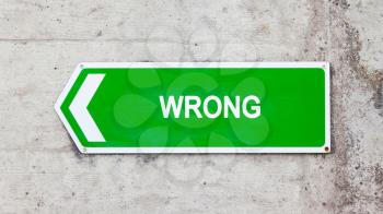 Green sign on a concrete wall - Wrong