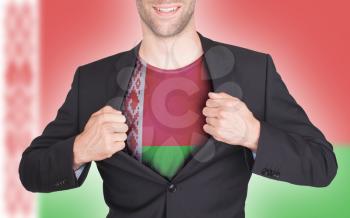 Businessman opening suit to reveal shirt with flag, Belarus