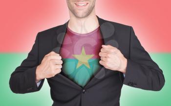 Businessman opening suit to reveal shirt with flag, Burkina Faso