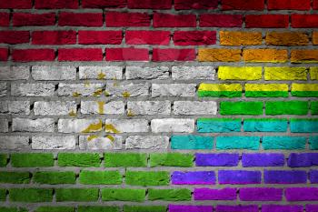 Dark brick wall texture - coutry flag and rainbow flag painted on wall - Tajikistan