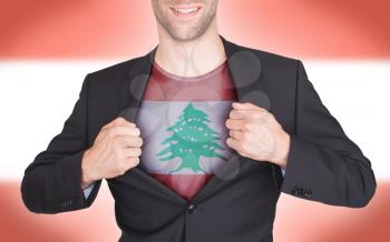 Businessman opening suit to reveal shirt with flag, Lebanon