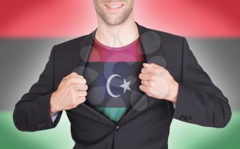 Businessman opening suit to reveal shirt with flag, Libya