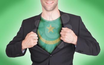 Businessman opening suit to reveal shirt with flag, Mauritania