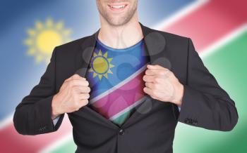 Businessman opening suit to reveal shirt with flag, Namibia