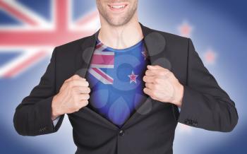 Businessman opening suit to reveal shirt with flag, New Zealand