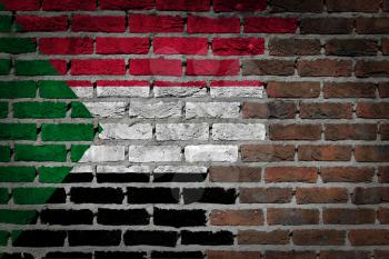 Very old dark red brick wall texture with flag - Sudan