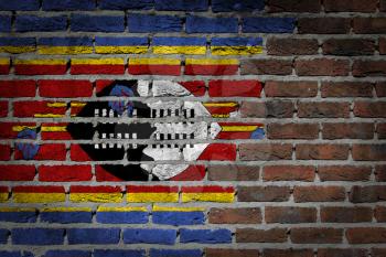 Very old dark red brick wall texture with flag - Swaziland