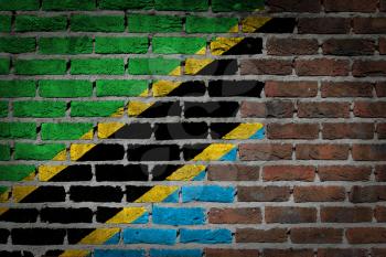 Very old dark red brick wall texture with flag - Tanzania