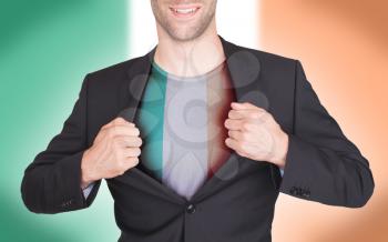 Businessman opening suit to reveal shirt with flag, Ireland
