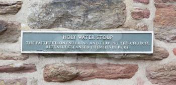 Sign at a holy water stoup at a ruin in Scotland
