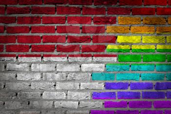 Dark brick wall texture - coutry flag and rainbow flag painted on wall - Monaco