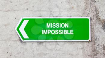 Green sign on a concrete wall - Mission impossible