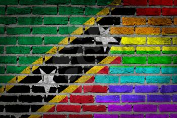 Dark brick wall texture - coutry flag and rainbow flag painted on wall - Saint Kitts and Nevis