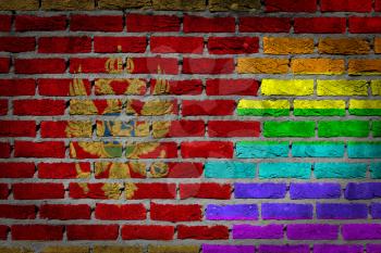 Dark brick wall texture - coutry flag and rainbow flag painted on wall - Montenegro