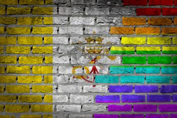 Dark brick wall texture - coutry flag and rainbow flag painted on wall - Vatican
