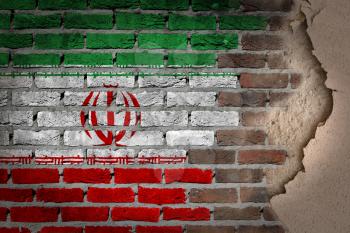 Dark brick wall texture with plaster - flag painted on wall - Iran