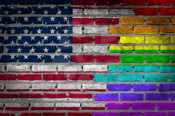 Dark brick wall texture - coutry flag and rainbow flag painted on wall -