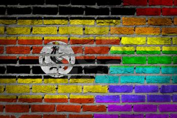 Dark brick wall texture - coutry flag and rainbow flag painted on wall - Uganda