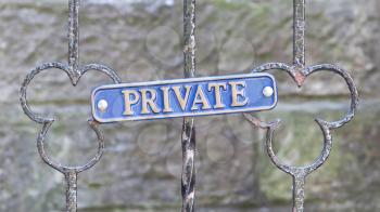 Old private sign on a metal gate