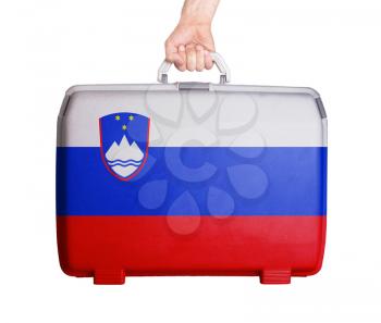 Used plastic suitcase with stains and scratches, printed with flag, Slovenia