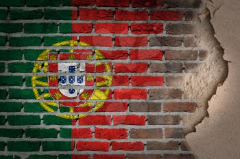 Dark brick wall texture with plaster - flag painted on wall - Portugal