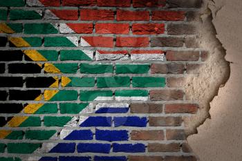 Dark brick wall texture with plaster - flag painted on wall - South Africa