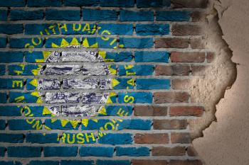 Dark brick wall texture with plaster - flag painted on wall - South Dakota