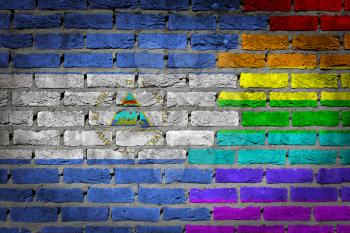 Dark brick wall texture - coutry flag and rainbow flag painted on wall - Nicaragua