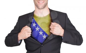 Businessman opening suit to reveal shirt with flag, Bosnia and Herzegovina