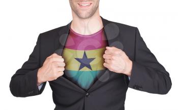 Businessman opening suit to reveal shirt with flag, Ghana