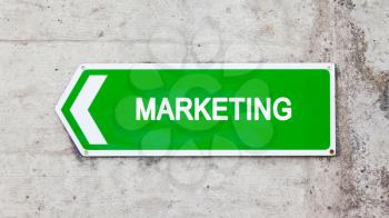 Green sign on a concrete wall - Marketing