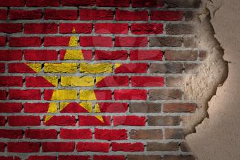 Dark brick wall texture with plaster - flag painted on wall - Vietnam