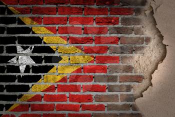 Dark brick wall texture with plaster - flag painted on wall - East Timor