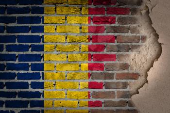 Dark brick wall texture with plaster - flag painted on wall - Romania