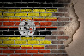 Dark brick wall texture with plaster - flag painted on wall - Uganda