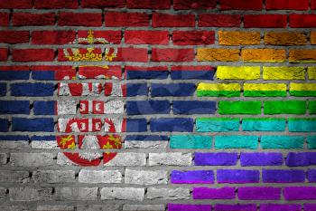 Dark brick wall texture - coutry flag and rainbow flag painted on wall - Serbia