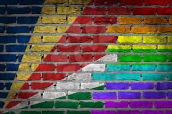 Dark brick wall texture - coutry flag and rainbow flag painted on wall - Seychelles