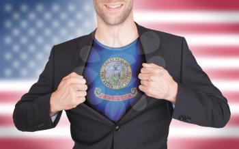 Businessman opening suit to reveal shirt with state flag (USA), Idaho