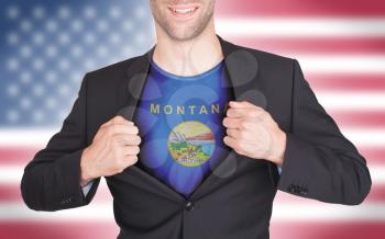 Businessman opening suit to reveal shirt with state flag (USA), Montana