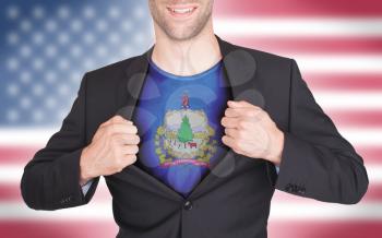 Businessman opening suit to reveal shirt with state flag (USA), Vermont