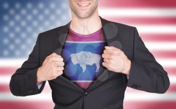 Businessman opening suit to reveal shirt with state flag (USA), Wyoming