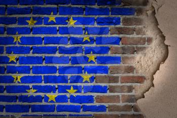 Dark brick wall texture with plaster - flag painted on wall - EU
