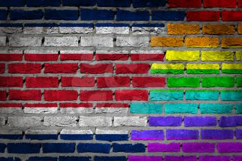 Dark brick wall texture - coutry flag and rainbow flag painted on wall - Costa Rica