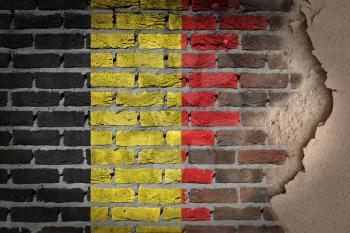Dark brick wall texture with plaster - flag painted on wall - Belgium
