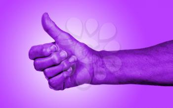 Old woman with arthritis giving the thumbs up sign, purple skin
