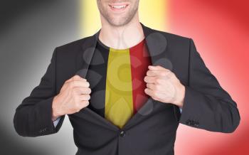 Businessman opening suit to reveal shirt with flag, Belgium