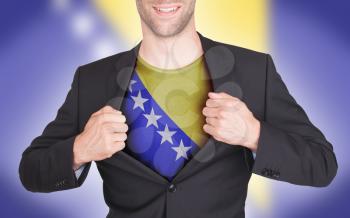 Businessman opening suit to reveal shirt with flag, Bosnia and Herzegovina