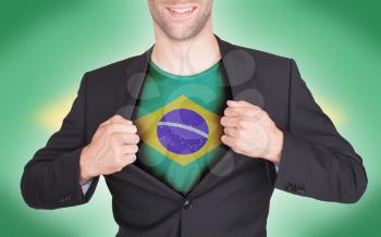 Businessman opening suit to reveal shirt with flag, Brazil